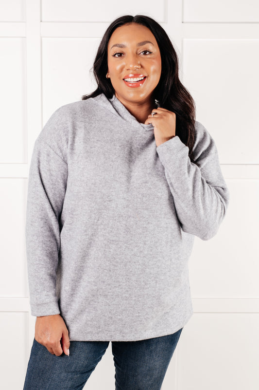 Heather grey pullover with soft brushed melange fabric, banded cuffs and hem, perfect for layering and everyday comfort.