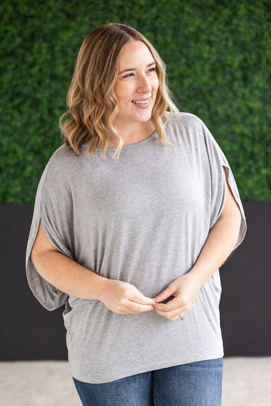 Darcy Dolman Top with trendy flowy sleeves and solid light grey color, offering superb stretch and comfort for any occasion, from work to evening outings.