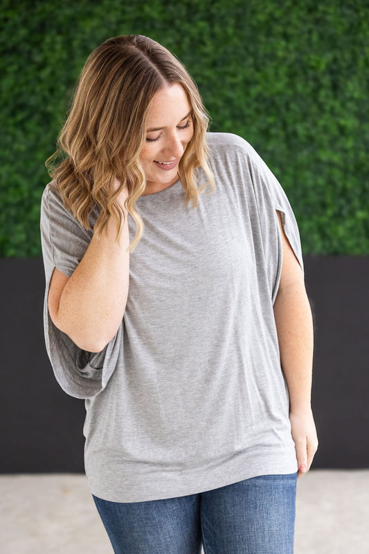 Darcy Dolman Top with trendy flowy sleeves and solid light grey color, offering superb stretch and comfort for any occasion, from work to evening outings.