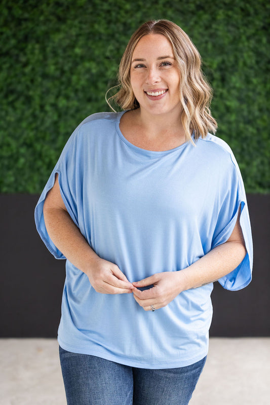 Darcy Dolman Top with trendy flowy sleeves and solid sky blue color, offering superb stretch and comfort for any occasion, from work to evening outings