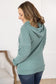 Sage color Pixie Pocket Halfzip Hoodie with triple stretch fabric, pocket on the sleeve, kangaroo pocket, and a feminine fit for comfort and style.