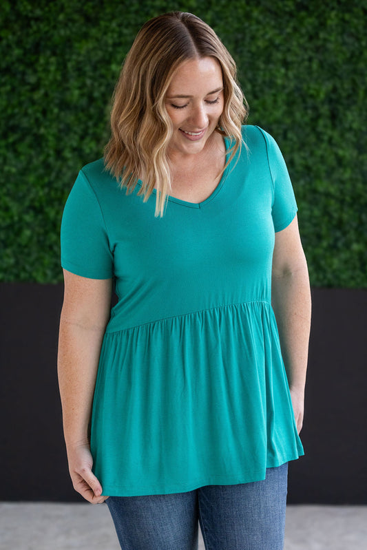 Sarah Ruffle Short Sleeve Top with flirty ruffle details and teal color, made from soft, stretchy fabric for a comfortable and flattering fit.